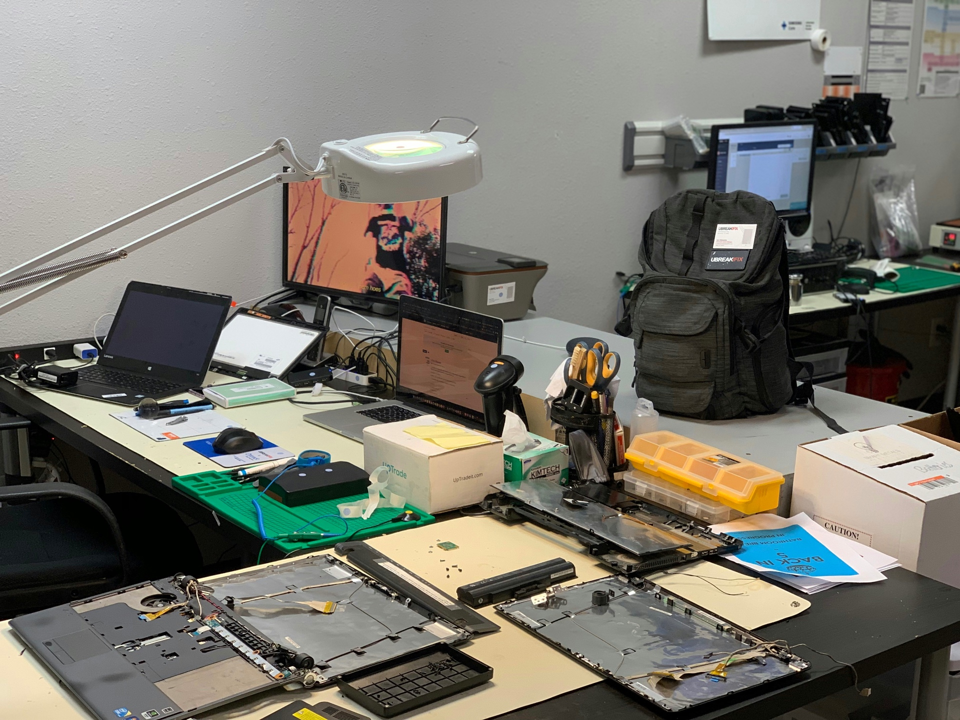 Laptops disassembled on the computer repair bench